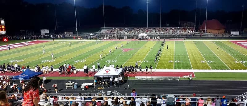 Police lights outside a high school football stadium