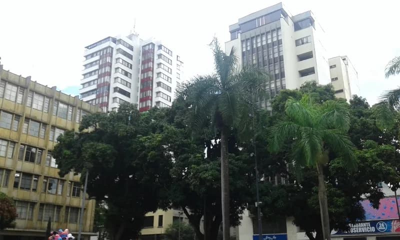 Collapsed apartment block on a debris-strewn street