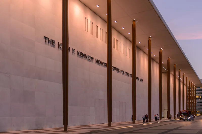 The exterior of a federal agency building in Washington with its seal beside the entrance