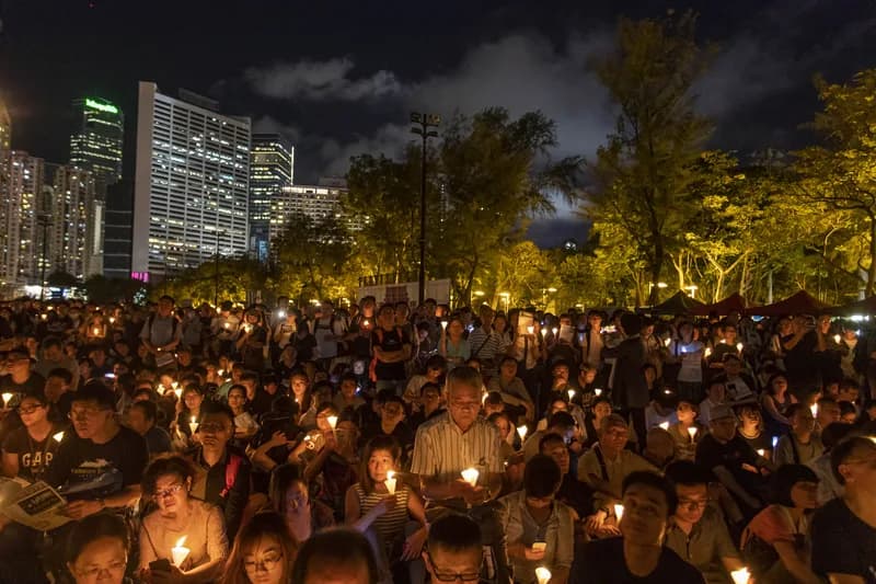 Candlelight held up at a night vigil in a city park