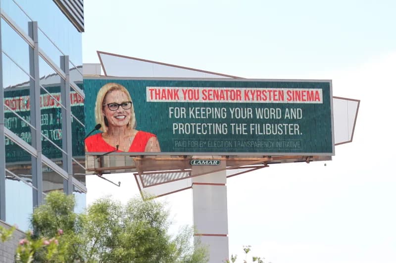 Kyrsten Sinema walking through a Senate corridor